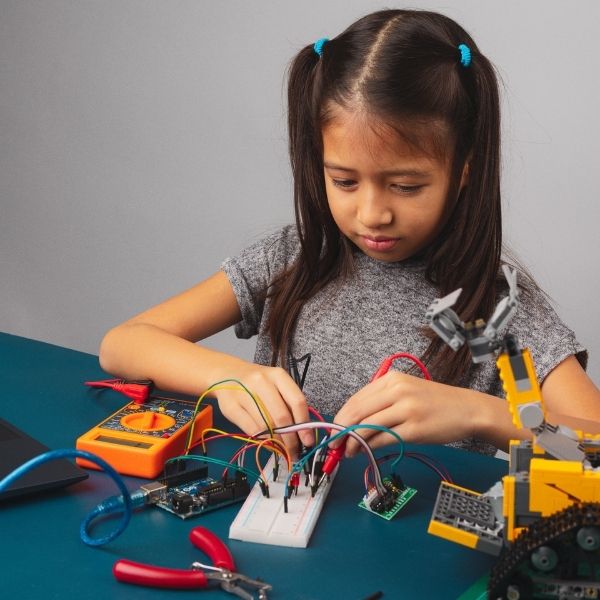 A young student programming an arduino board. 