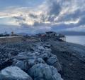 Looking south, down a line of rocks placed on the west side of Homer Spit Road above the Kachemak Bay shoreline.