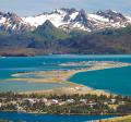 Landscape photo of Homer Spit and across Kachemak Bay to snow capped mountains