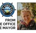 Photo of Mayor Lord smiling and standing next to sunflowers with the words From the Office of the Mayor and ship's wheel logo.