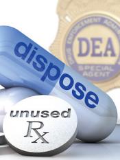 DEA badge in background with a silver medicine pill and blue capsule in the foreground.