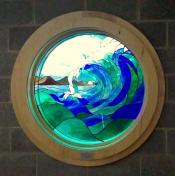 A stained glass window of a white capped wave.