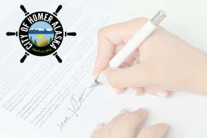 Close-up image of woman's hand signing signature on piece of paper with a white pen