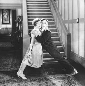 Black and white scene from Buster Keaton movie.  Man and woman holding each other up.