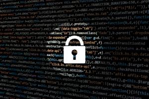 Black background with white lock in front of computer programming language