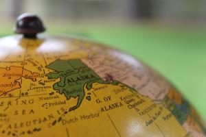 Top part of a globe showing the State of Alaska.
