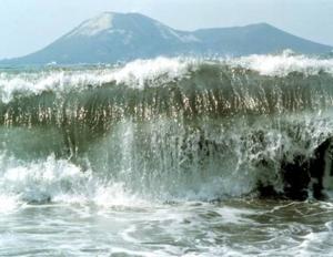 Large wave in front of mountains