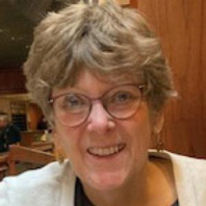 A smiling woman wearing glasses