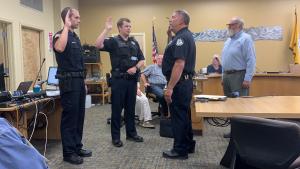 Officers Kellen Stock (left) and Tyler Jeffres (middle) are sworn in by Chief Robl at Homer City Council Meeting, Aug 26, 2019