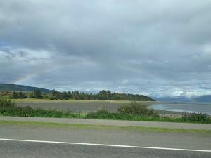 Photo of Mud Bay with rainbow hovering over top 