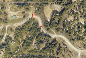 Aerial imagery of Highland Road with topographic lines. Red lines drawn across the road indicate the closure at Bidarki Creek