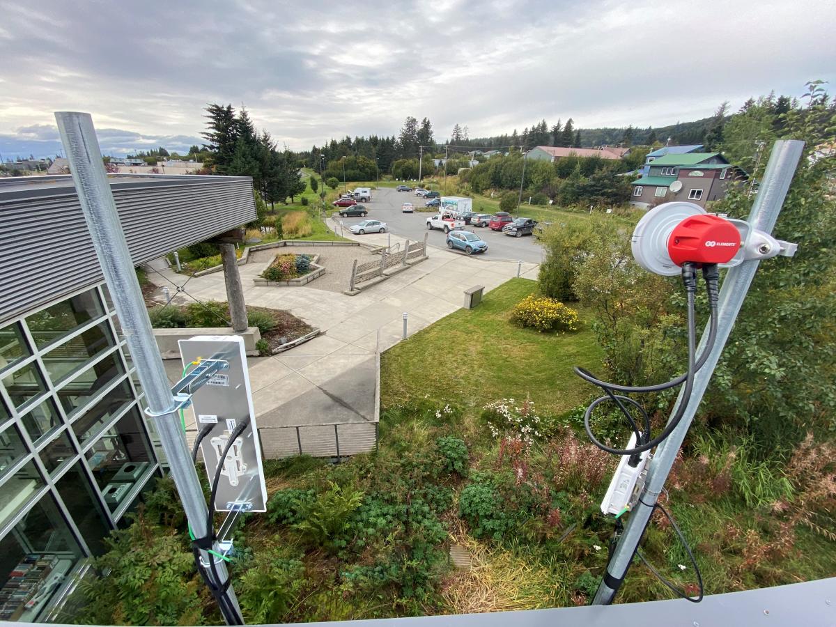 A view of the library parking lot from behind the new WiFi antennae