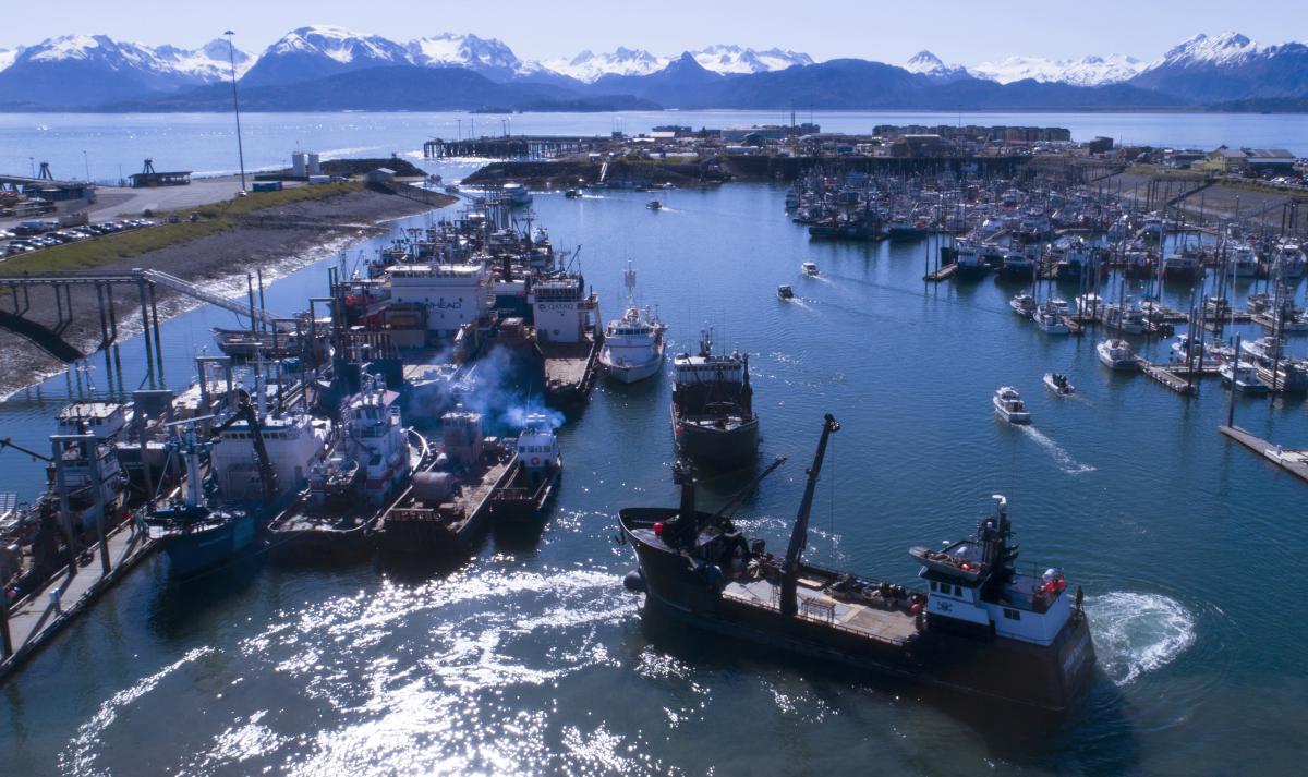 Photo showing large vessels rafted three and four abreast and traffic congestion in the small boat harbor.