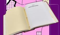 A thick book opened to page titled Title 21 Zoning and Planning with a pink colored zoning map in the background.