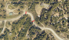 Highland Drive Road closure Aerial imagery of Highland Road with topographic lines. Red lines drawn across the road indicate the closure at Bidarki Creek